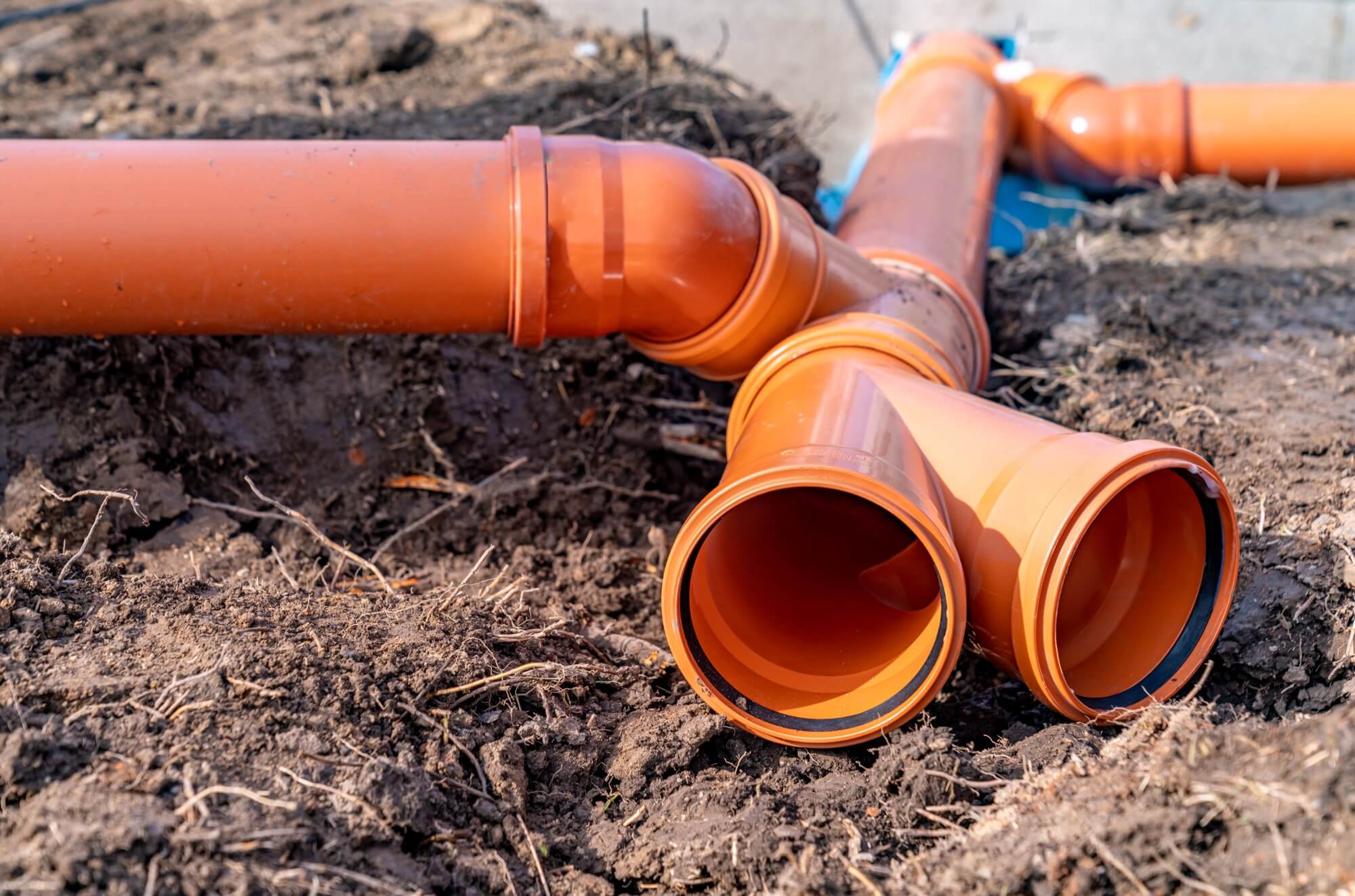 Orange fittings connected in a drainage system during installation in .